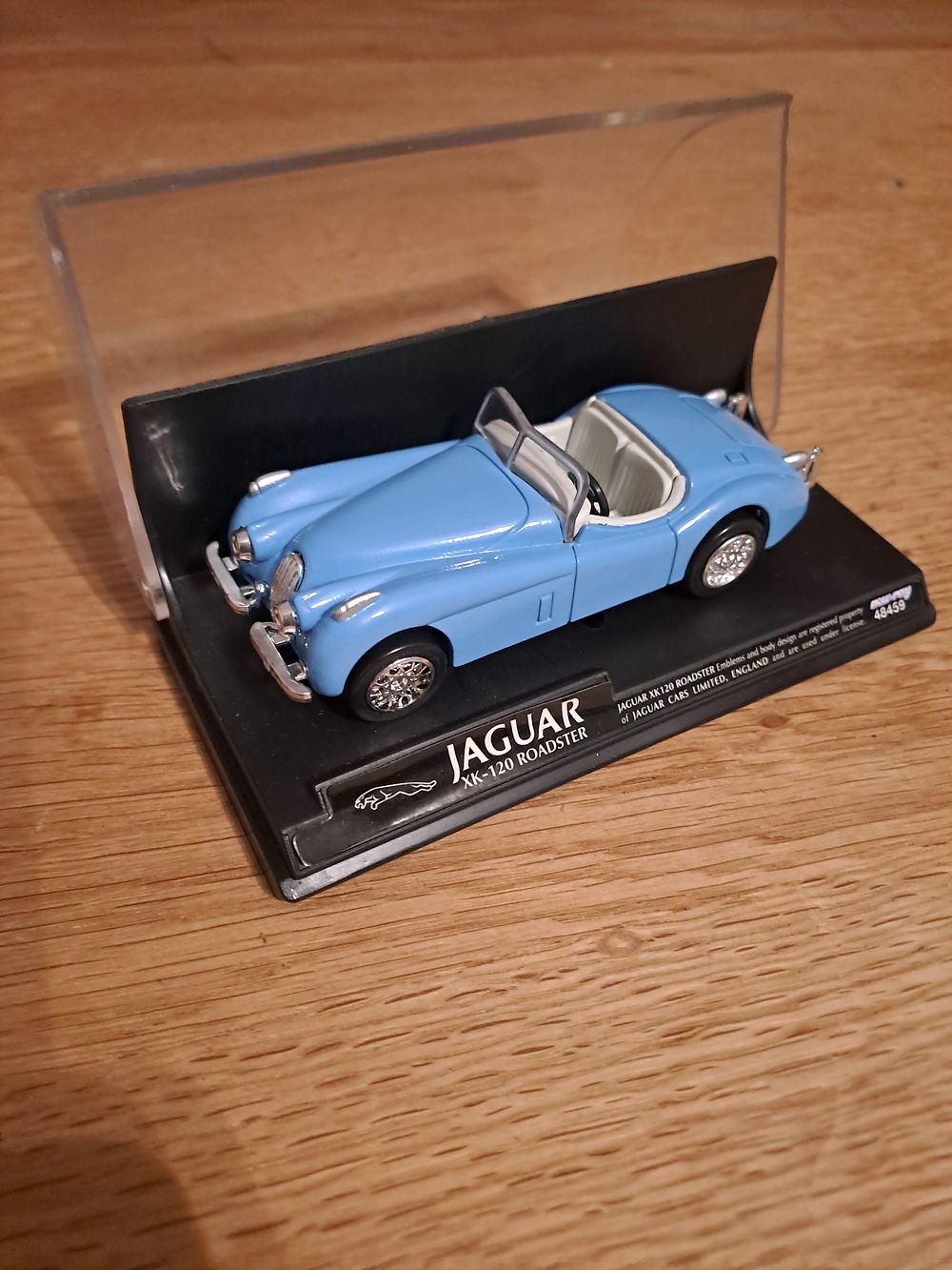 Lot 435: NEW-RAY JAGUAR XK-120 ROADSTER in baby blue and white interior good condition and case scale 1/43