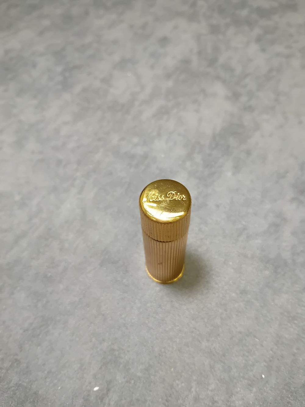 Lot 570: Christian Dior Small Travel Perfume bottle in gold. 