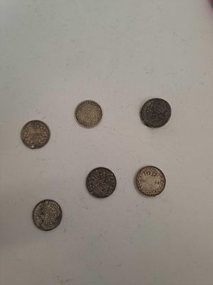 5 coins from around the world with various dates as pictured