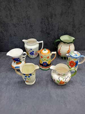 Mixed Lot of Wade and Other Vintage Floral Jugs and Pitchers 
This vibrant mixed lot includes 