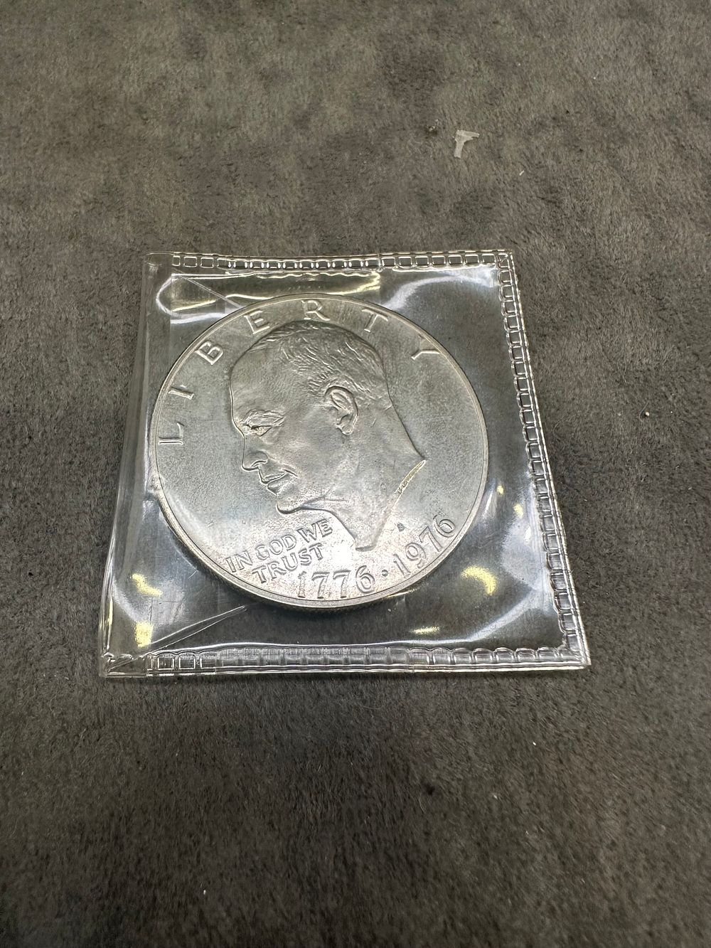 Lot 259: The 1976 Eisenhower Dollar had a one year reverse design displaying the Liberty Bell as well as an image of the moon in the background.