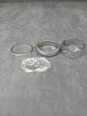 Mixed lot of Silver Coloured Bangles as pictured. Ones Made in Hongkong.
