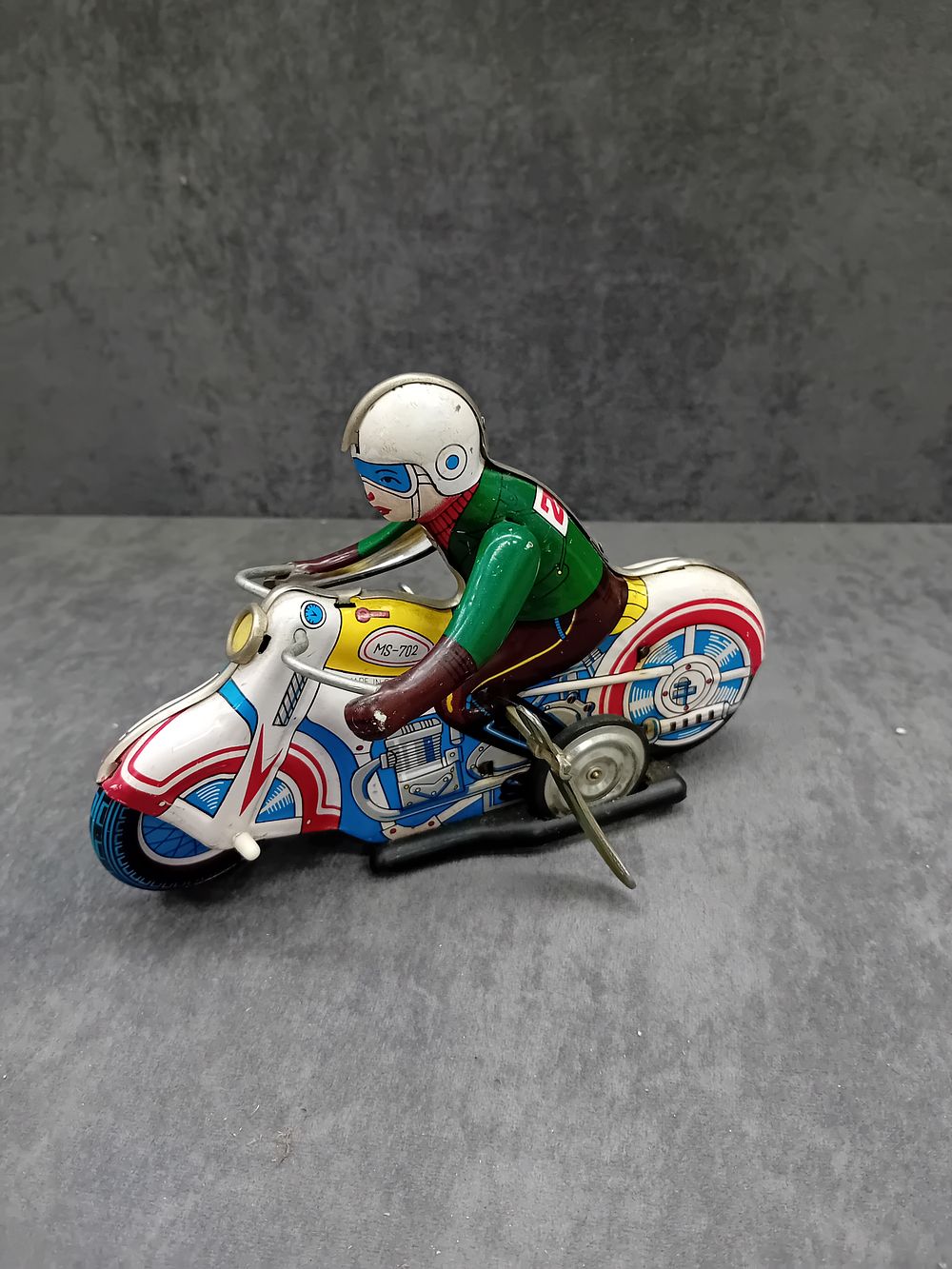 Lot 573: Tin Toy motorbike with rider made in China...