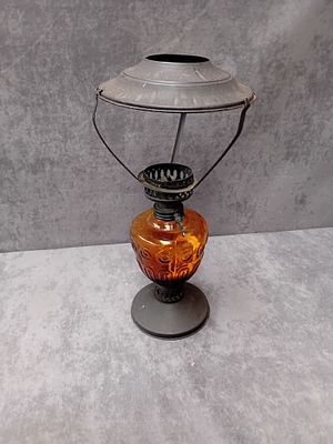 Antique oil lamp with orange glass base as pictured