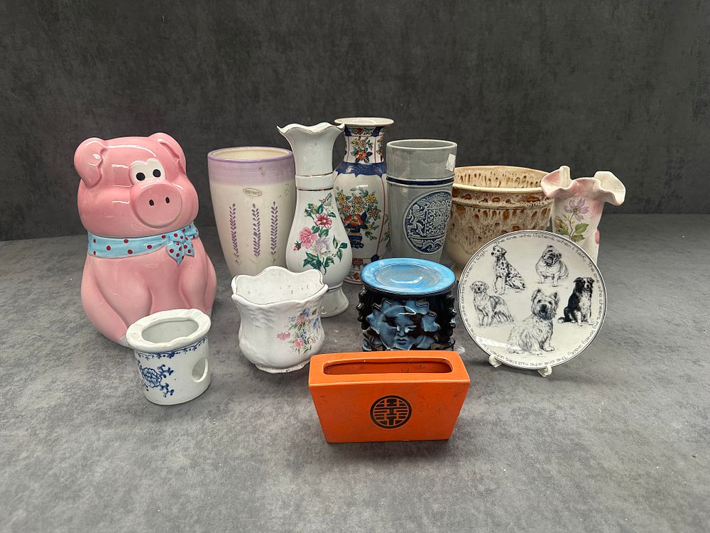 Lot 286: Mix a lot of 12 ceramics includes a pig shaped biscuit jar, vases, oil burners, and other items as pictured