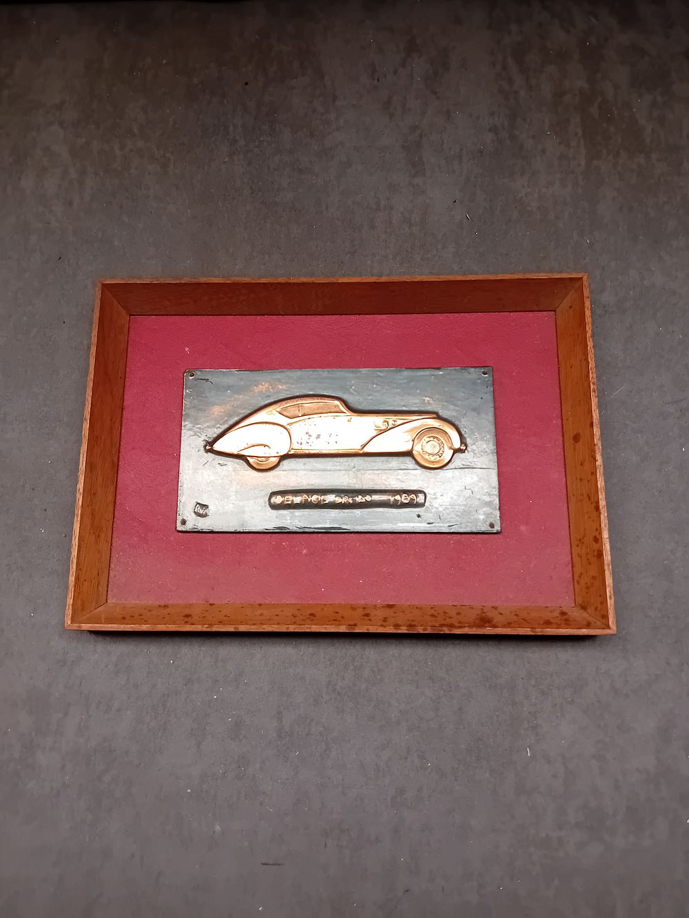 Lot 183: A Framed Hand Wrought Copper or Brass Bas-Relief Plaque by Richard C Hanscomb, depicting a Delage D8-120 1939