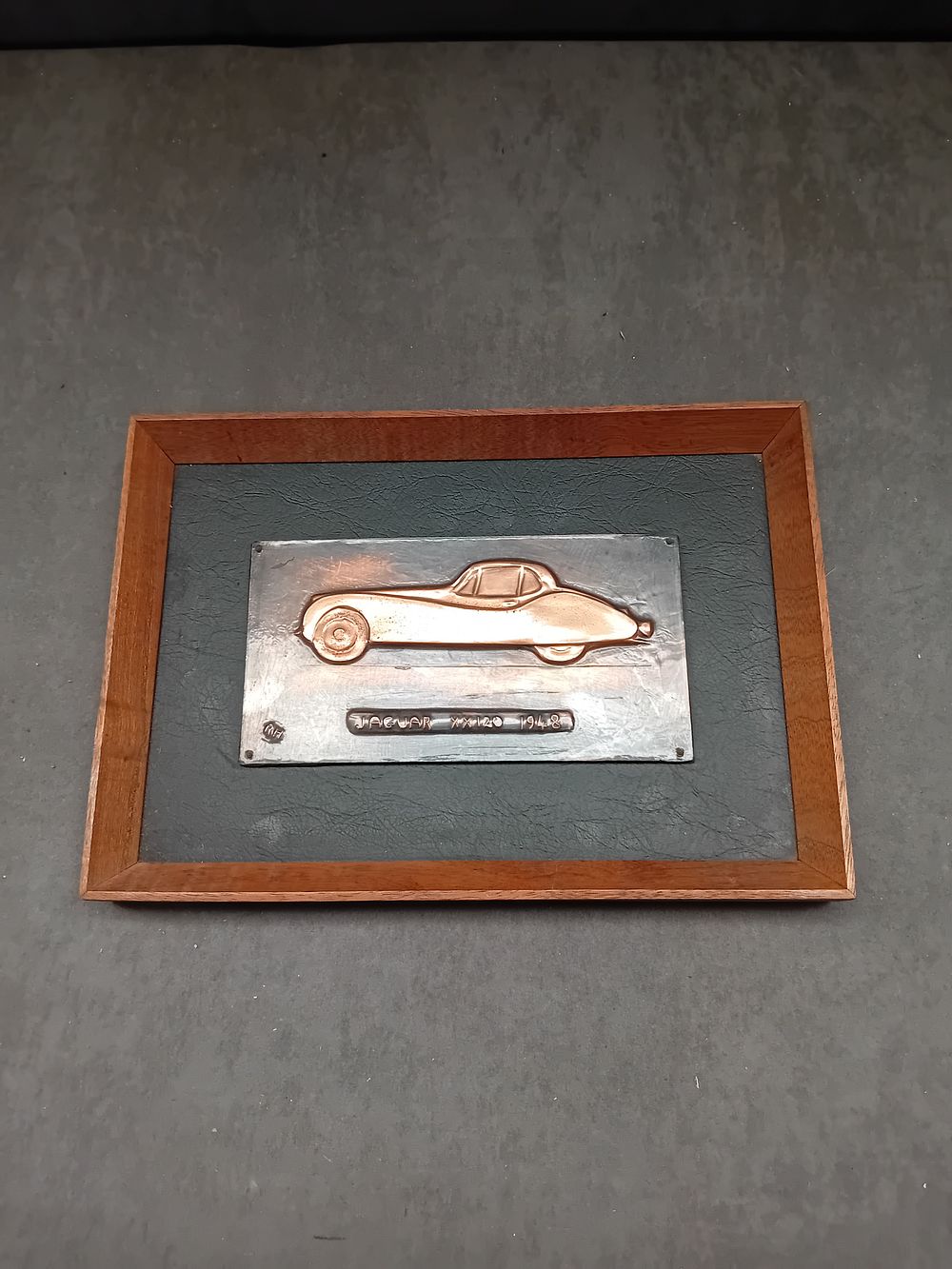 Lot 184: A Hand-Wrought Copper Relief Wall Plaque of a Jaguar XK120 by Richard G. Manscome, 1948