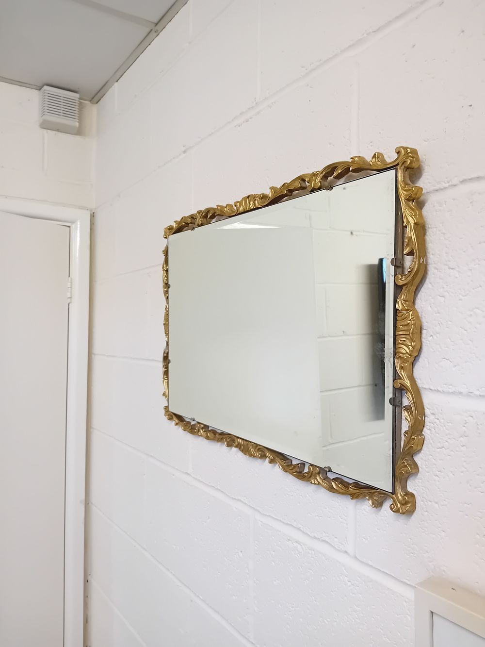 Lot 454: A Reflectwell Hollywood Regency Style Gilt Composite Wall Mirror