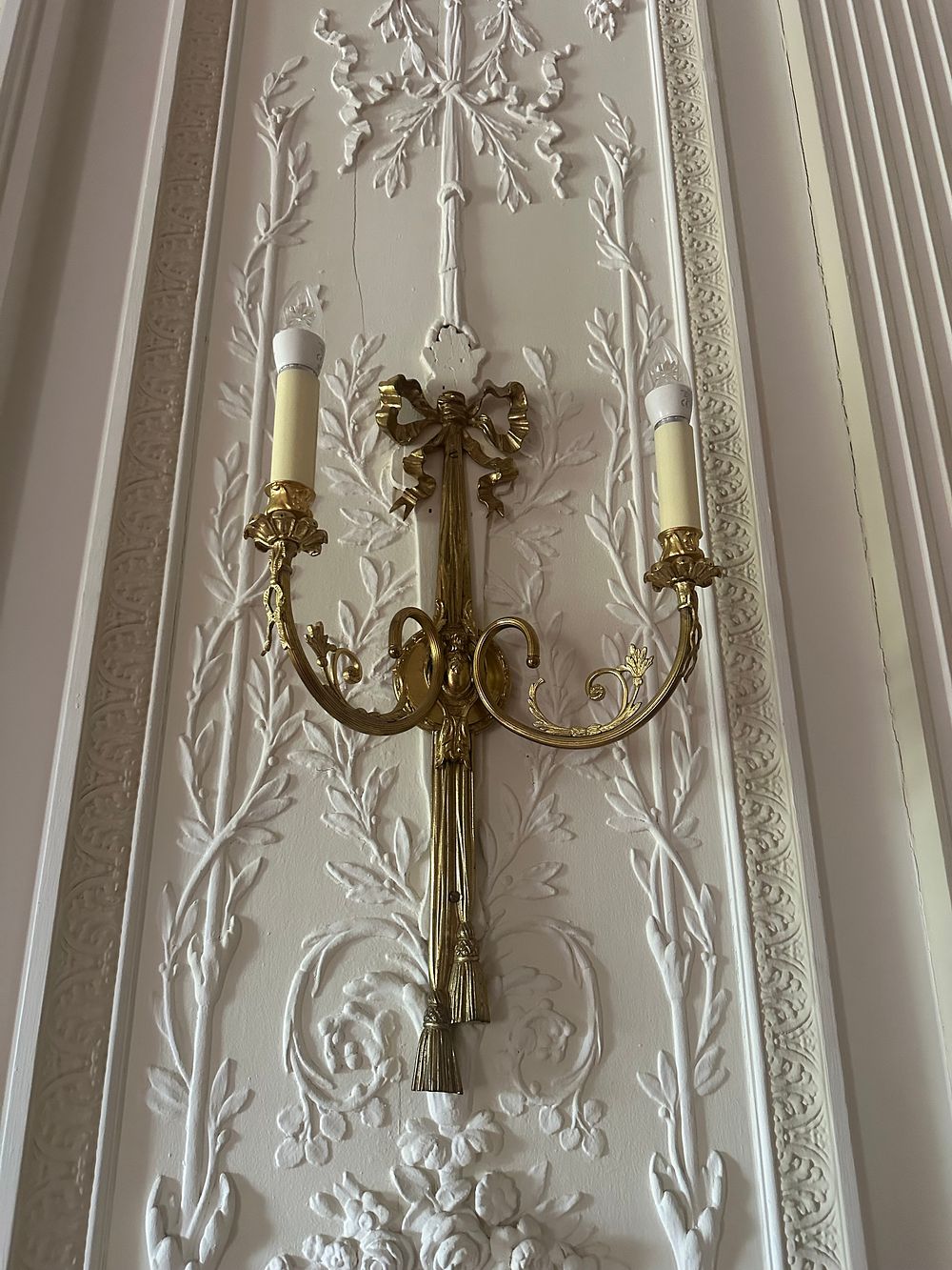 Lot 1023: A Group of Four French Louis XVI Style Brass Two-Light Wall Sconces