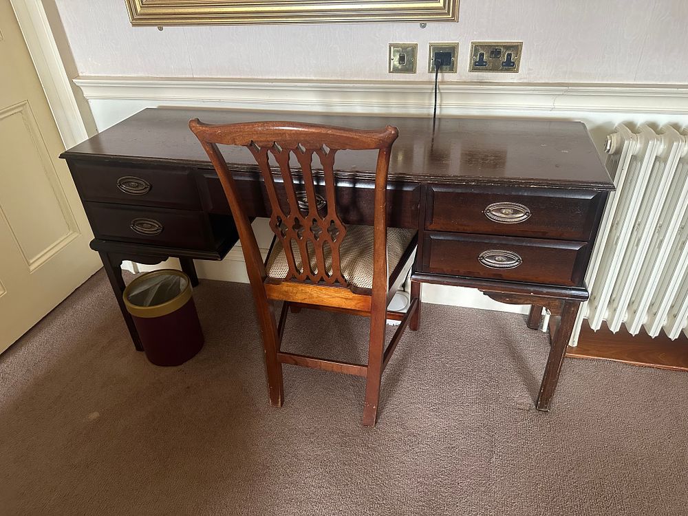 Lot 1076: An Edwardian Style Dark-Stained Wood Kneehole Desk and Chair