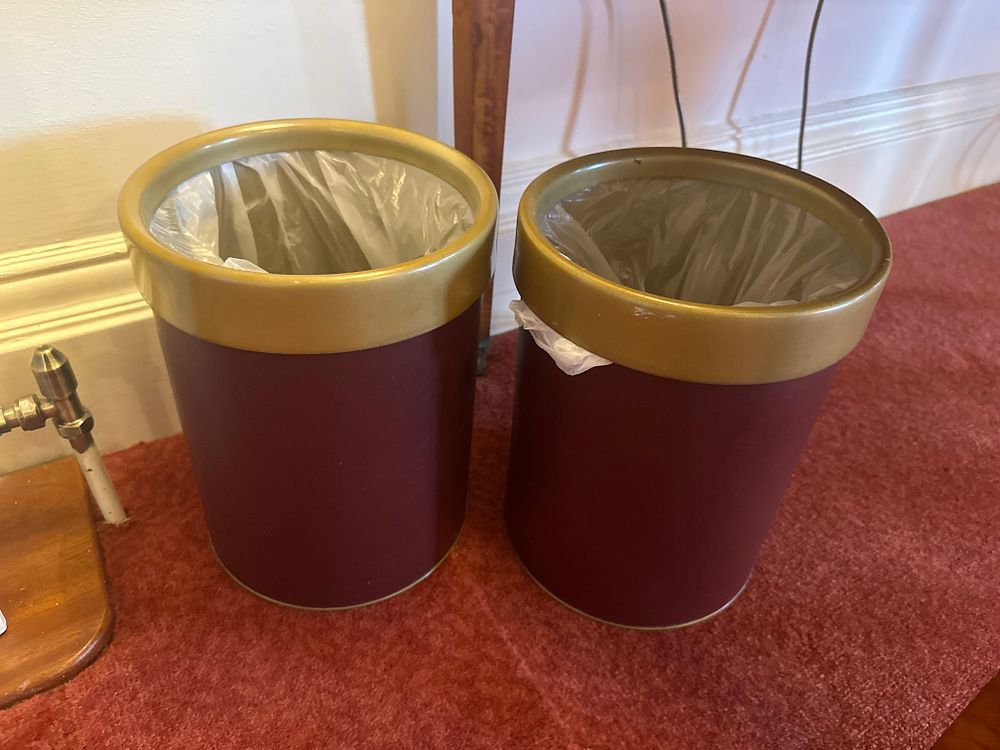 Lot 1147: A Pair of Modern Burgundy Faux Leather and Gold-Tone Waste Bins