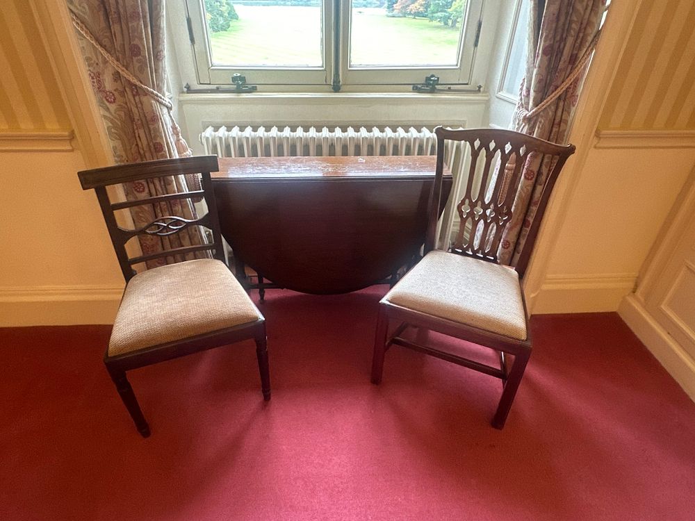 Lot 1163: A Three-Piece Dark-Stained Wood Dining Set, Comprising Two Non-Matching Chairs and a Drop-Leaf Folding Table