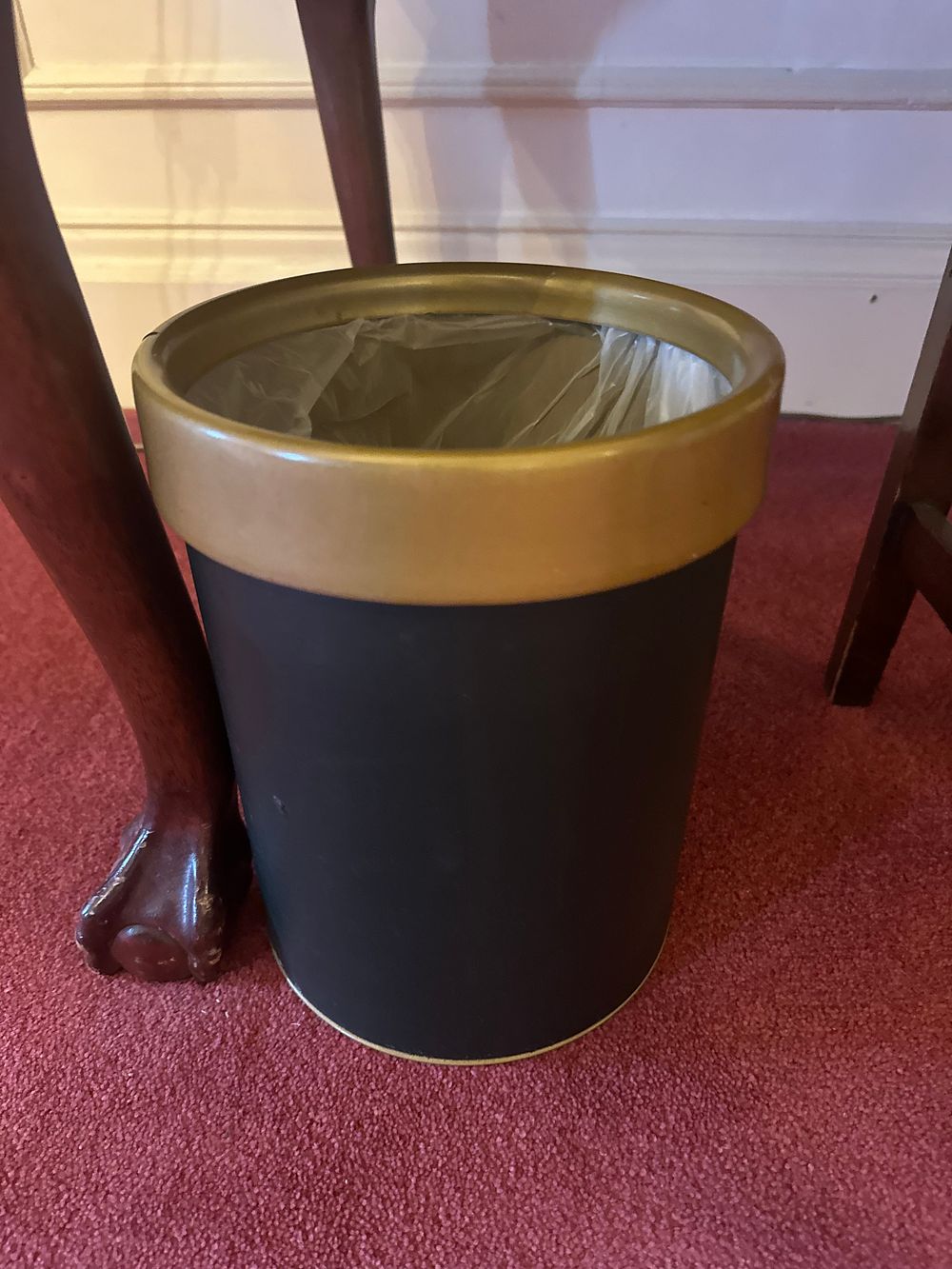 Lot 1174: A Black and Gold-Tone Cylindrical Waste Bin