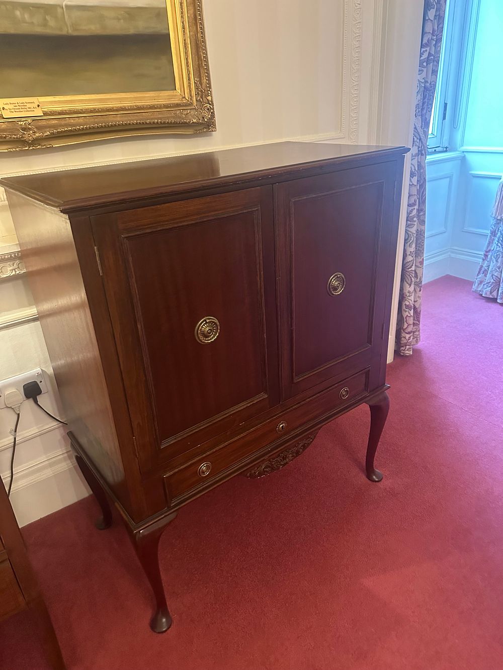 Lot 1189: A Queen Anne Style Mahogany TV Cabinet, including television