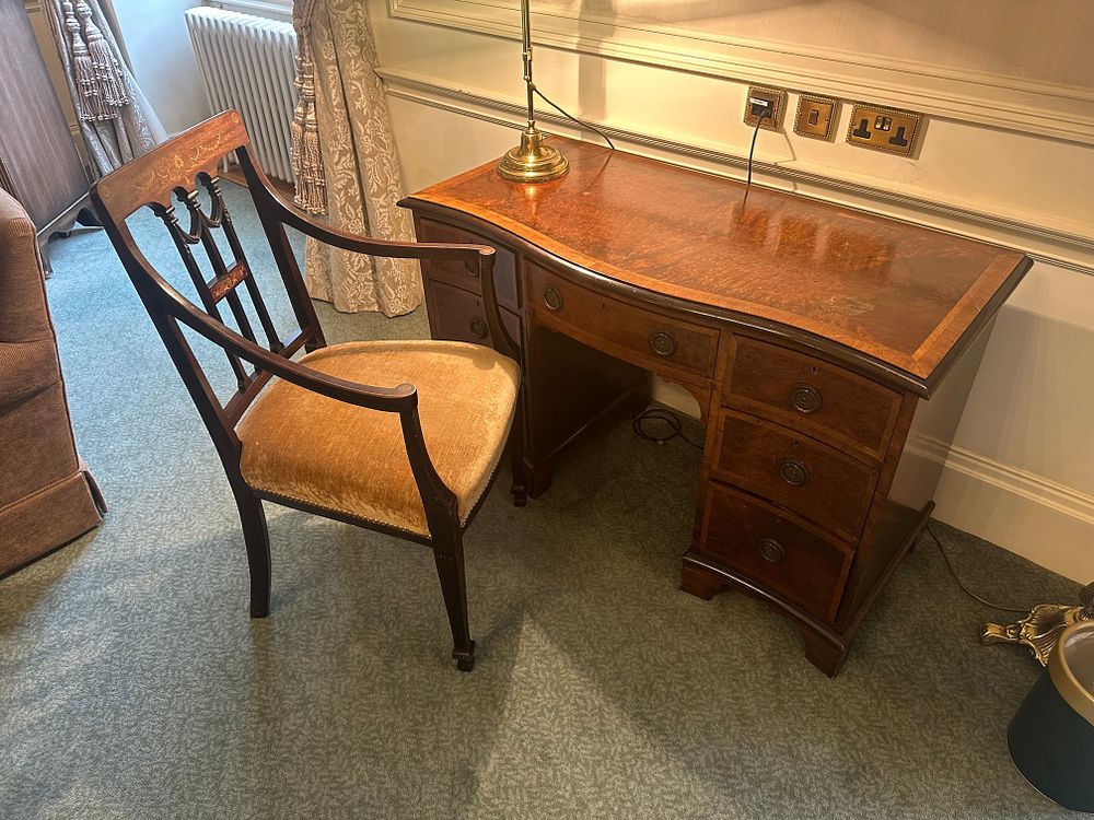 Lot 1226: A Matched Set Comprising a Mahogany Bow-Front Pedestal Desk and Armchair, in Georgian/Regency Style