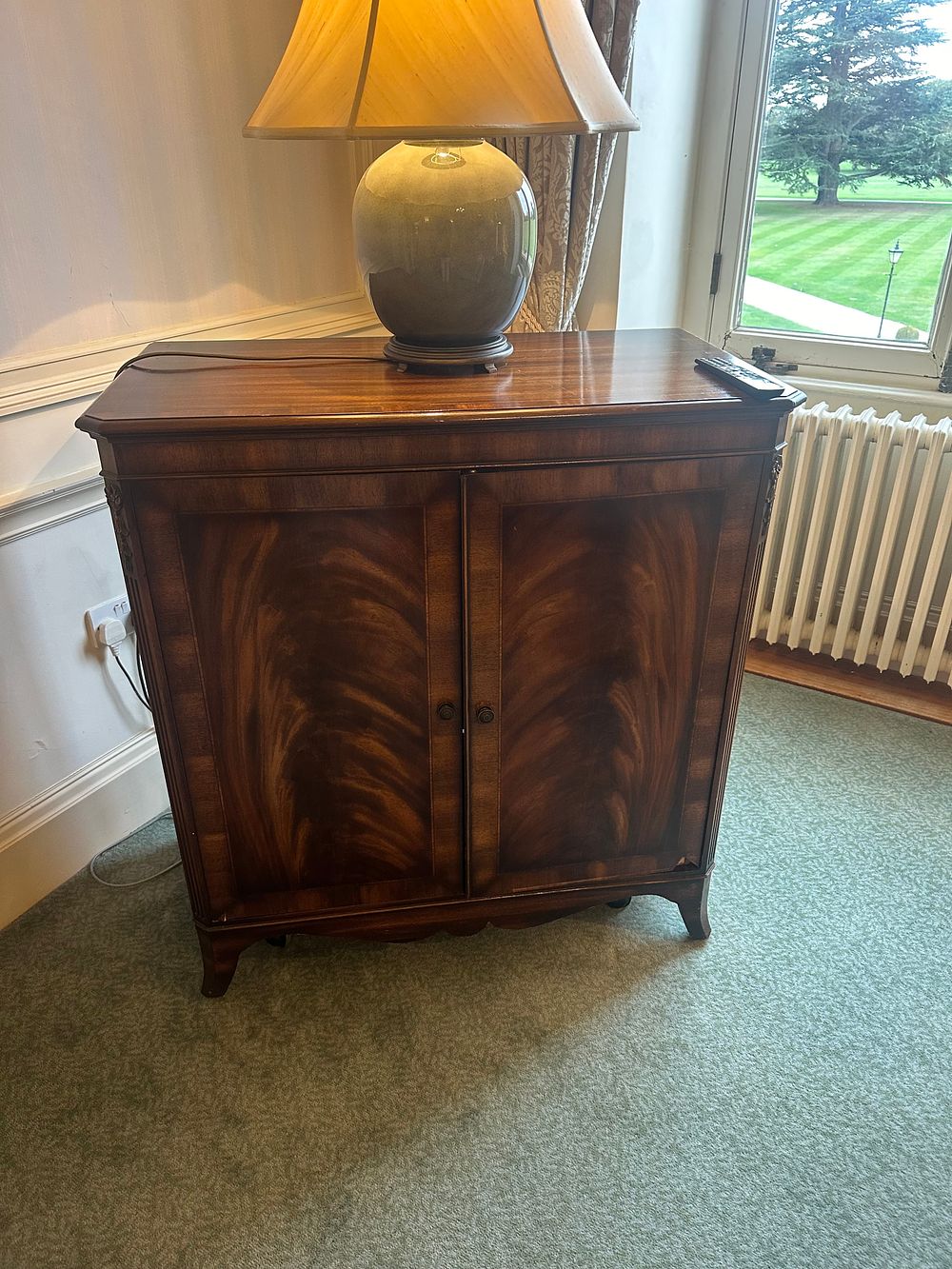 Lot 1227: A Mahogany Bow-Front Television Cabinet in Neoclassical / Regency Revival Style, with Toshiba REGZA LCD TV included