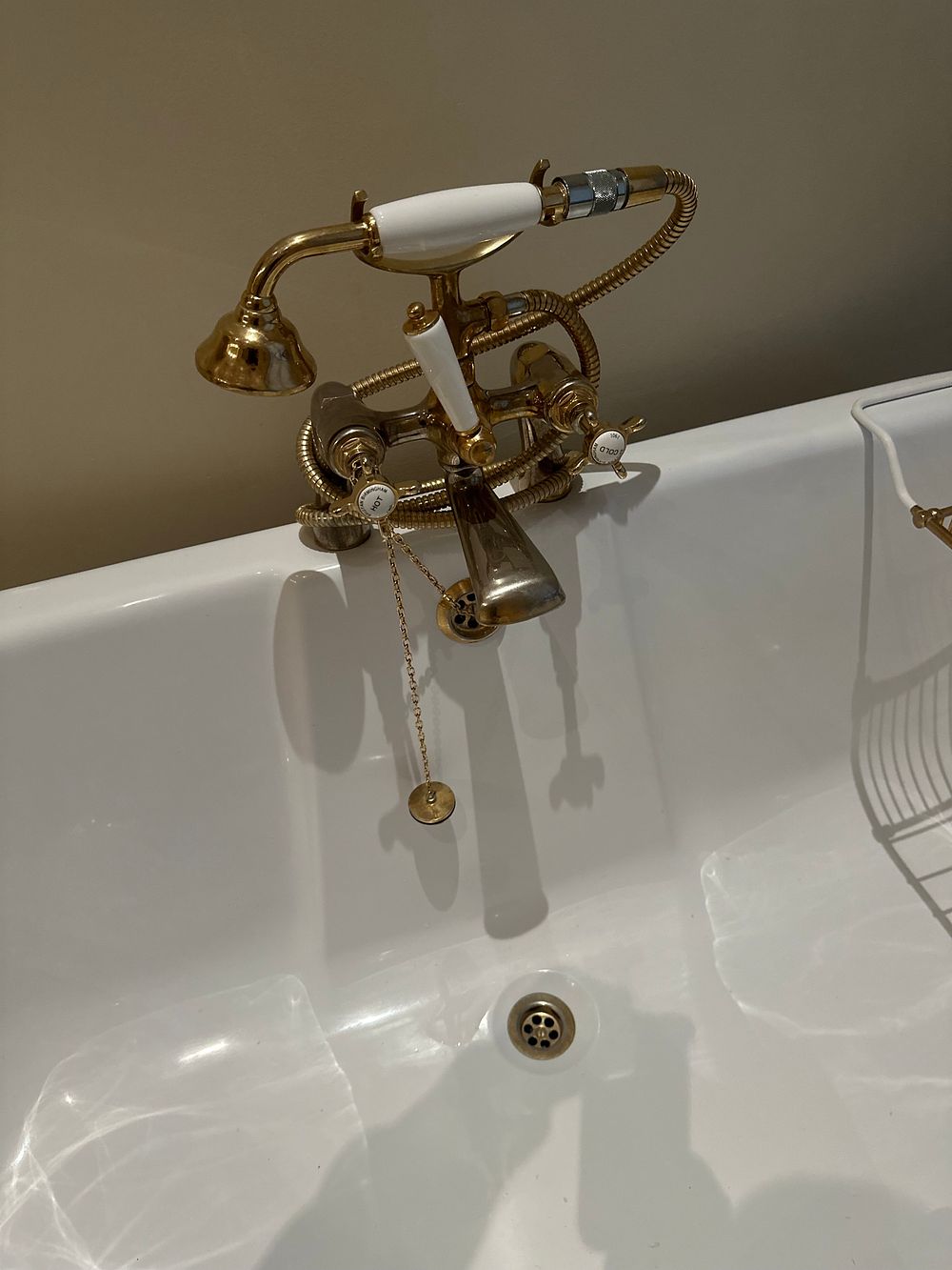Lot 1260: A Victorian/Edwardian Revival Style White Enameled Clawfoot Bathtub with Brass-Toned British Telephone Faucet Set