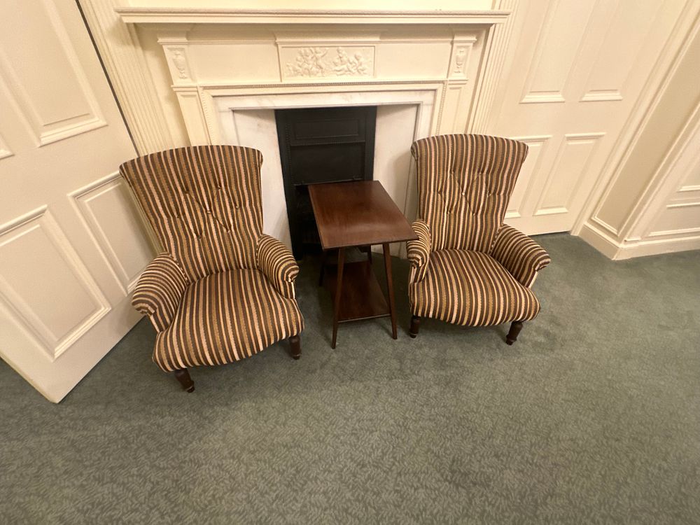 Lot 1263: A Pair of Striped Upholstered Wingback Armchairs and a Two-Tiered Side Table