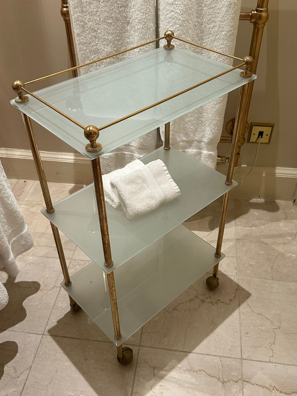 Lot 1330: A Hollywood Regency Style Brass-Tone and Frosted Glass Three-Tier Service Cart