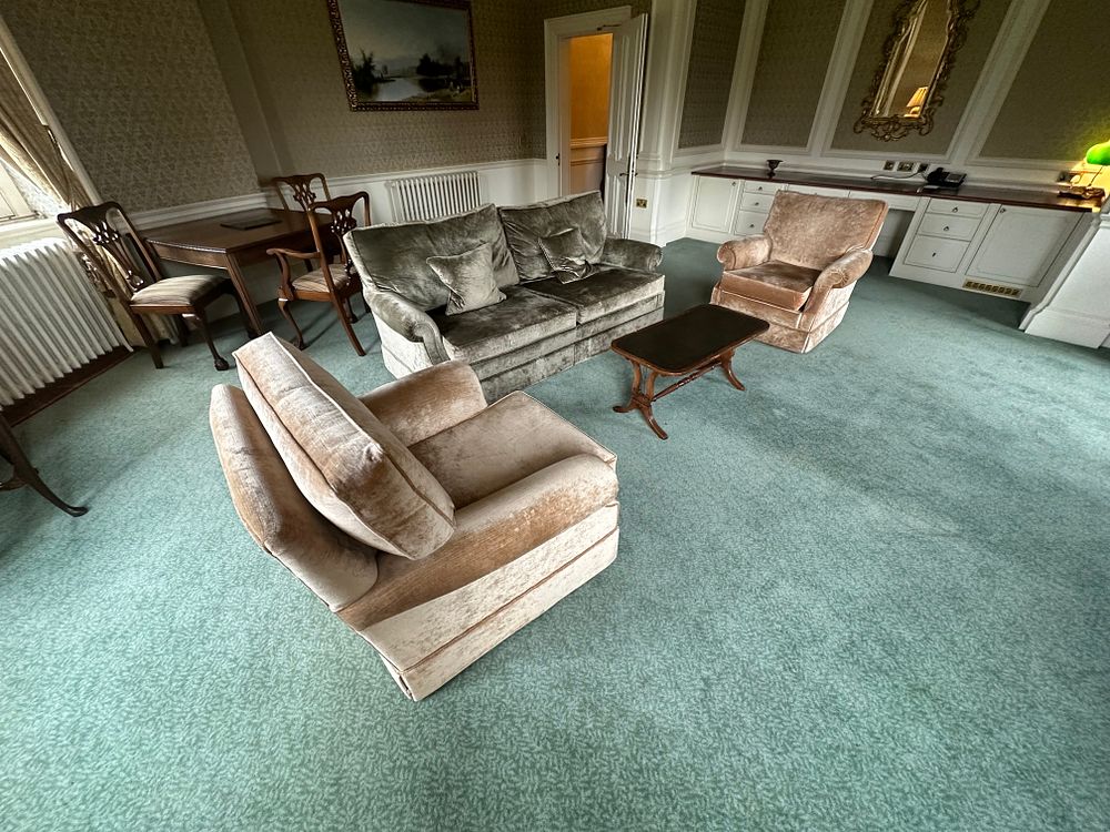 Lot 1337: A 20th Century Upholstered Three-Piece Suite, comprising a Sofa and Two Armchairs, with an accompanying Coffee Table