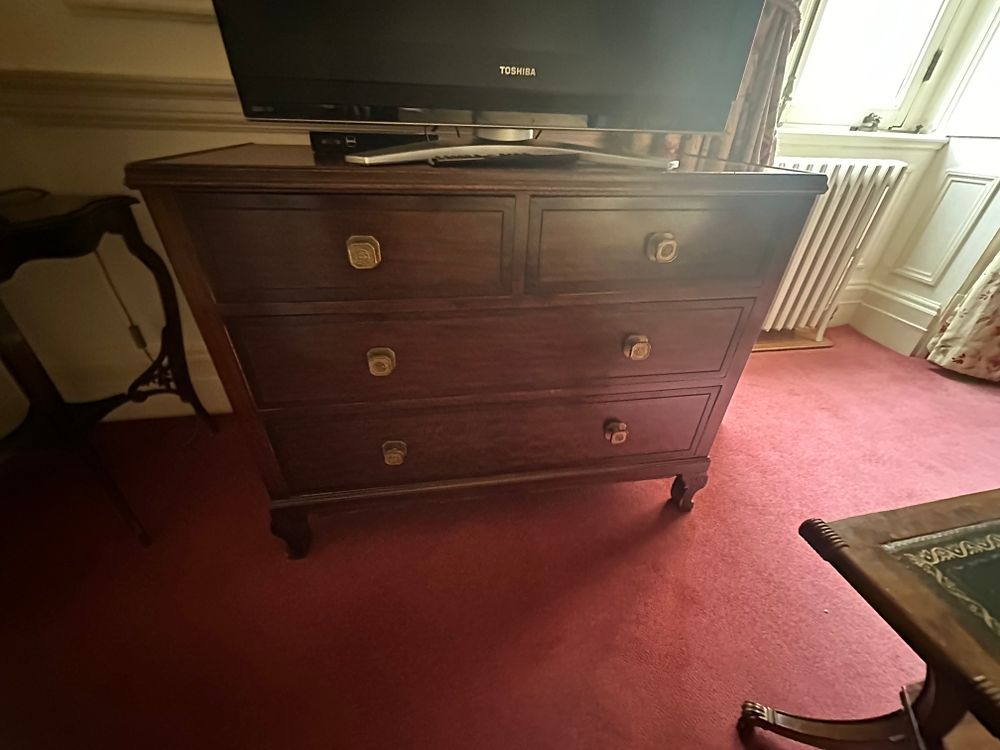 Lot 1353: A Dark-Stained Hardwood Four-Drawer Chest of Drawers