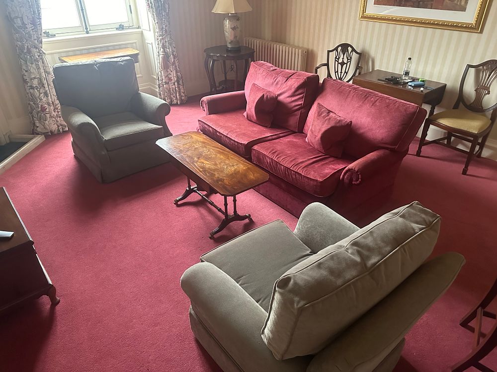 Lot 1400: A Traditional Living Room Ensemble Comprising a Sofa, A Pair of Armchairs, and a Drop-Leaf Coffee Table