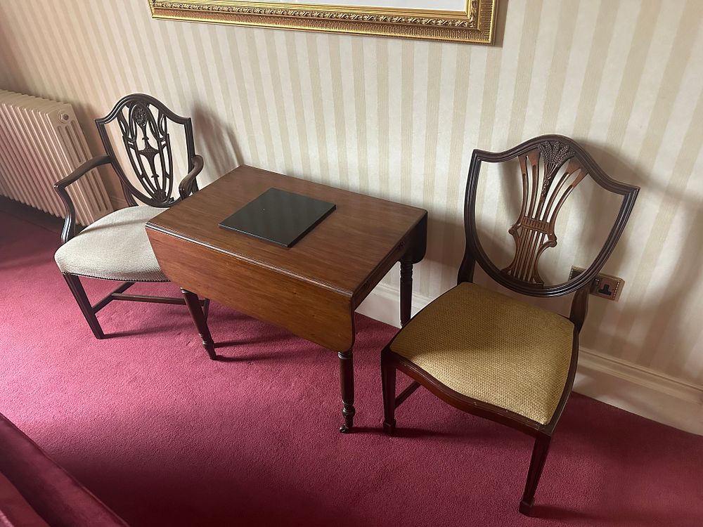 Lot 1402: A Late 18th-Century Hepplewhite Style Mahogany Drop-Leaf Table and Two Shield-Back Chairs