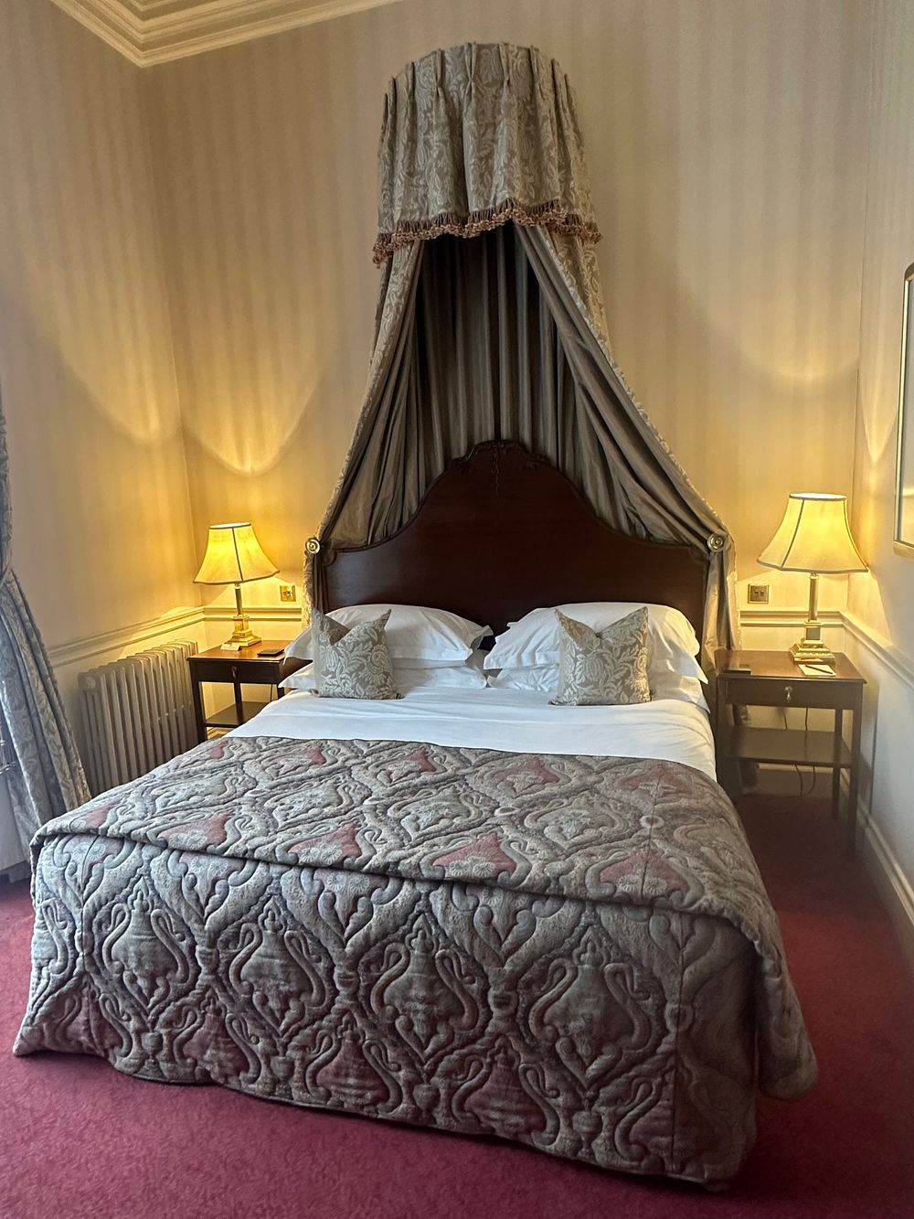 Lot 1411: A Classical Revival Style Dark-Stained Wooden Bed Ensemble with Fabric Half-Tester Canopy