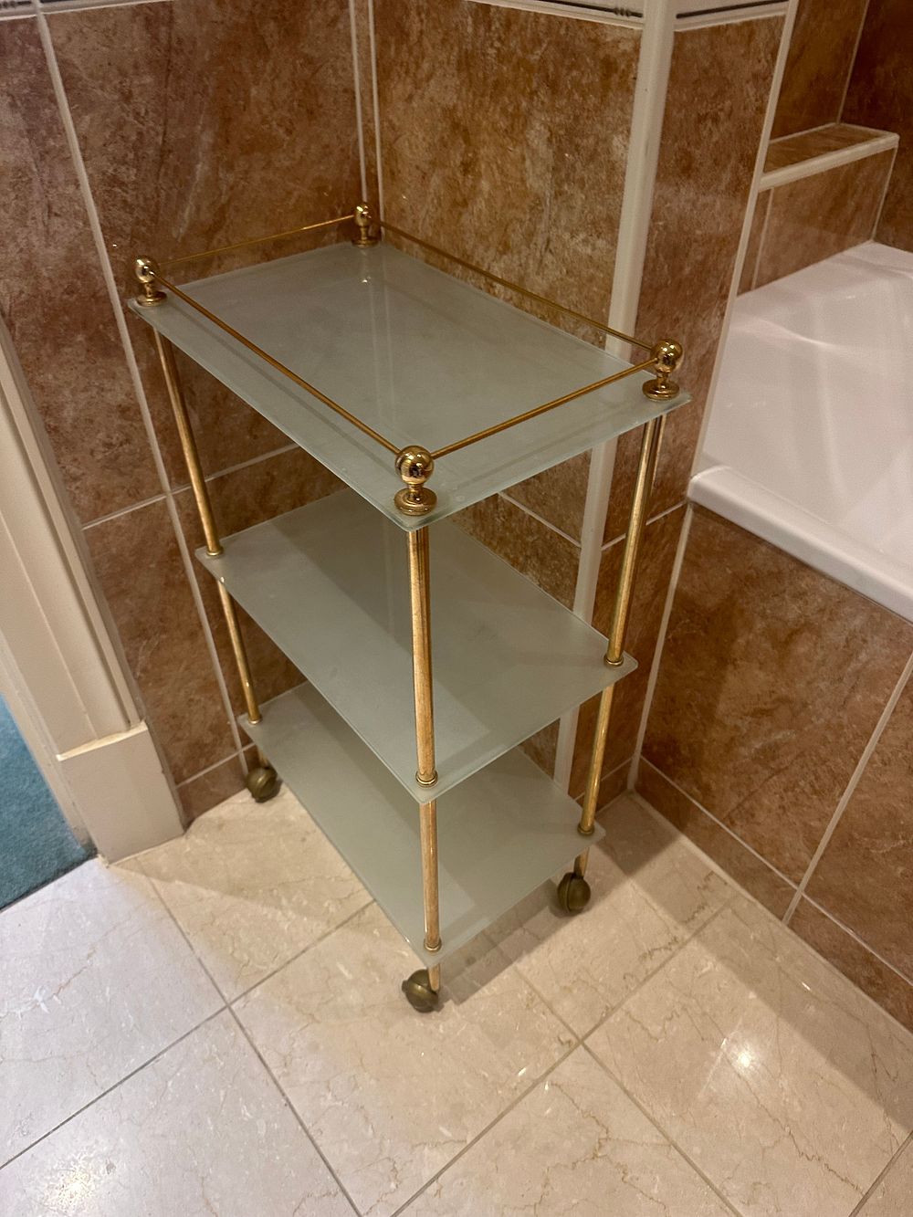 Lot 1430: A Traditional Brass-Tone Metal and Glass Three-Tier Rolling Bar Cart