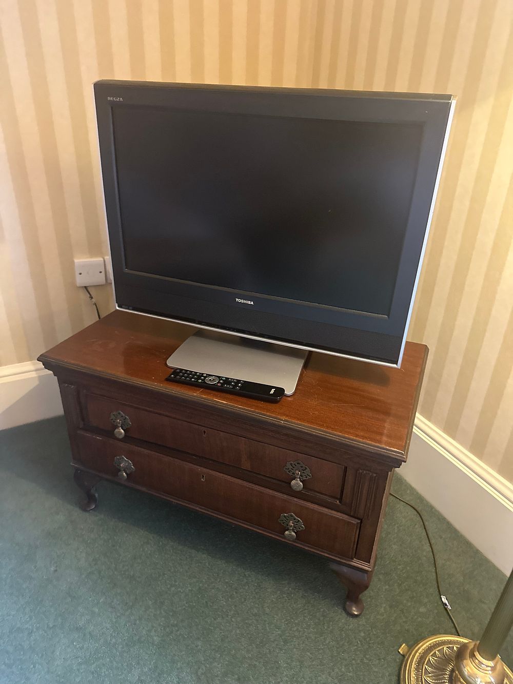 Lot 1453: A Toshiba Regza 26WLT66 26-inch Television with Remote Control and a Period Style Wooden Media Cabinet