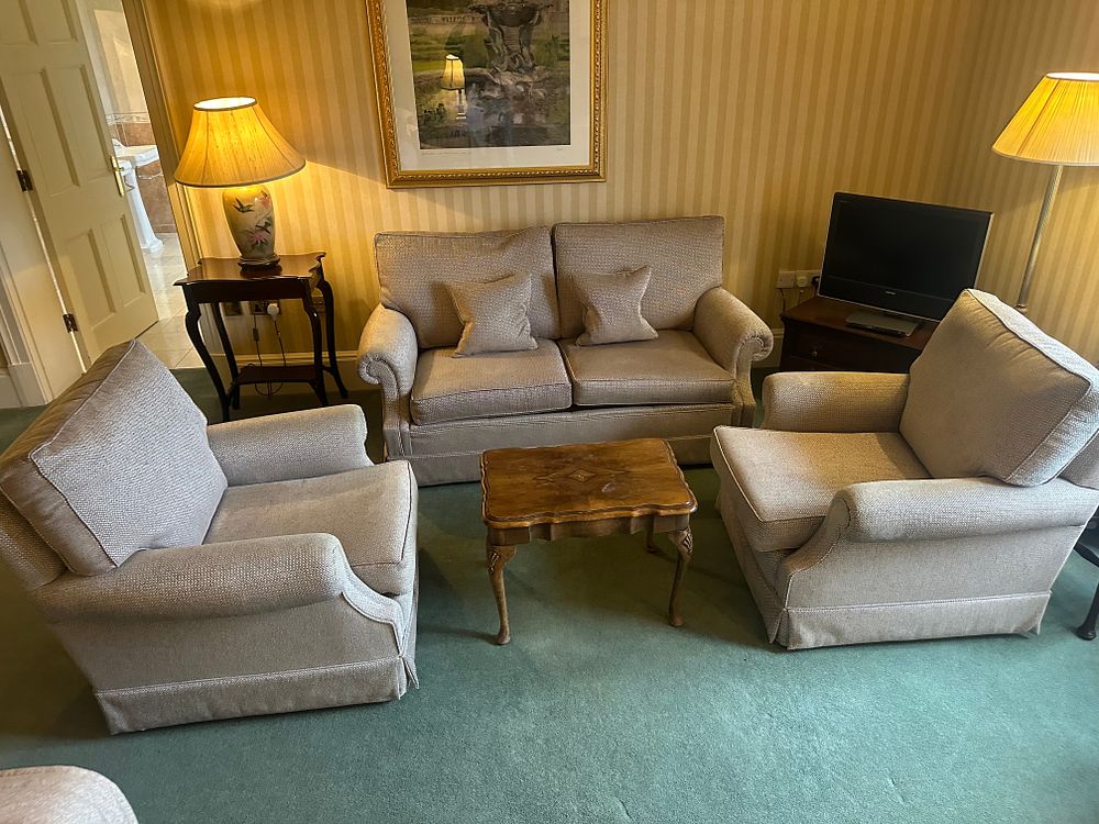 Lot 1454: A Sofa, Two Armchairs, and an Occasional Table