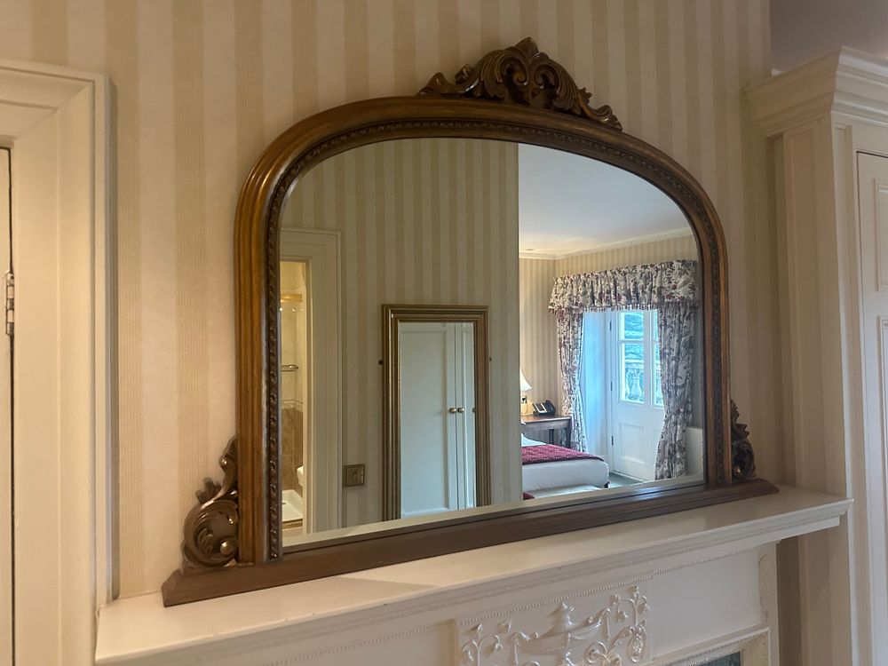 Lot 1460: A Rococo Revival Style Arched Hardwood Wall Mirror
