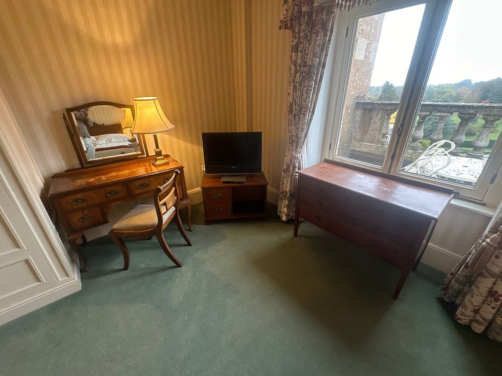 Lot 1466: A Mixed Lot of Brown Furniture, comprising a Dressing Table with Mirror, Chair, TV Stand, and Chest of Drawers, Early 20th Century Revival Style