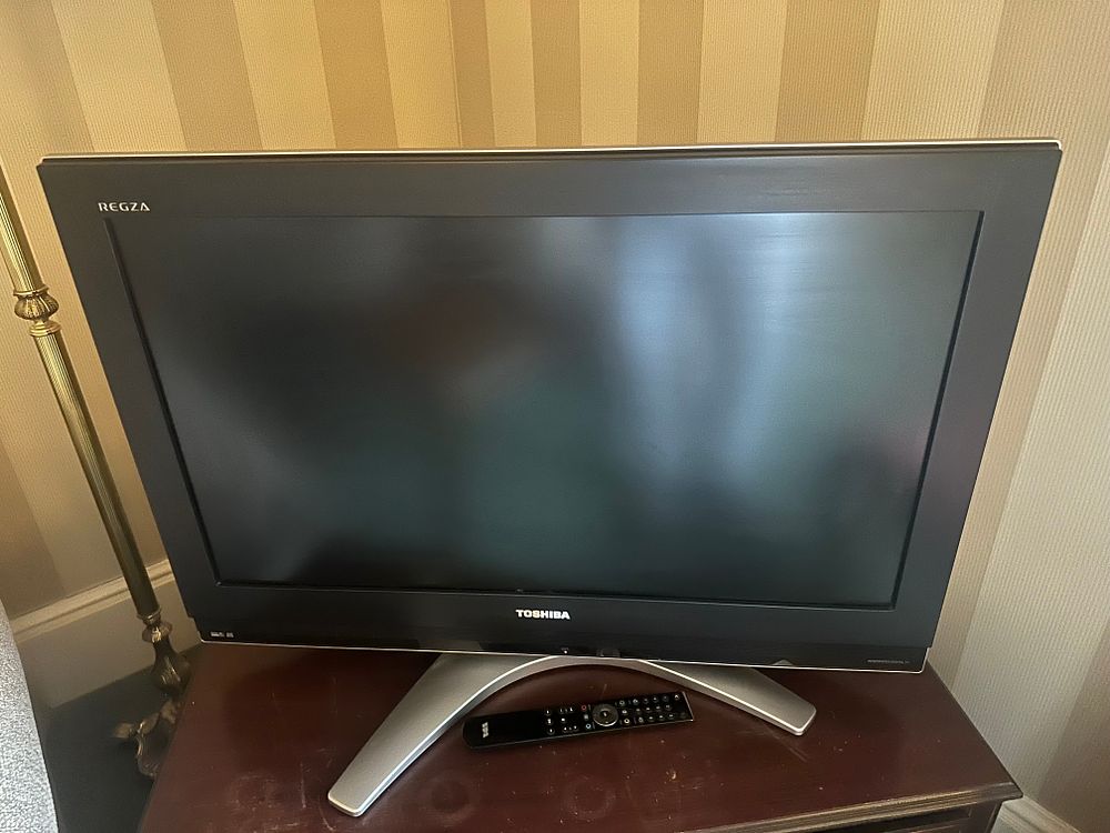 Lot 1478: A Toshiba REGZA LCD Television and a Dark-Stained Wood Chest of Drawers