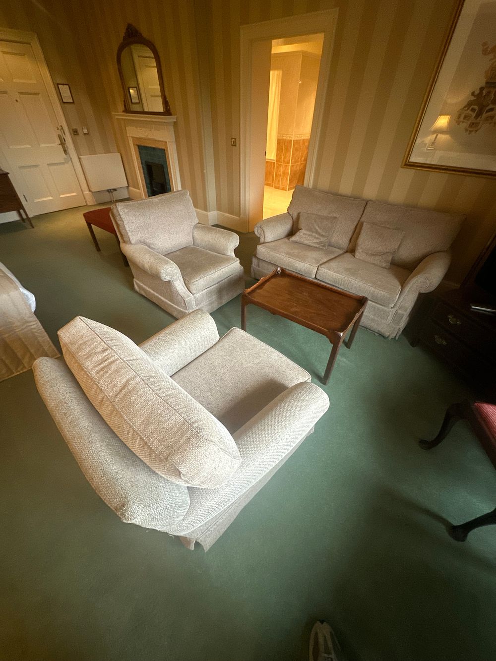 Lot 1483: A Suite Comprising Two Armchairs, a Sofa, and an Occasional Table