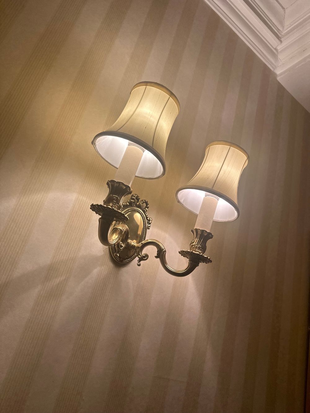 Lot 1490: A Pair of 1920s Colonial Revival Brass Two-Light Wall Sconces