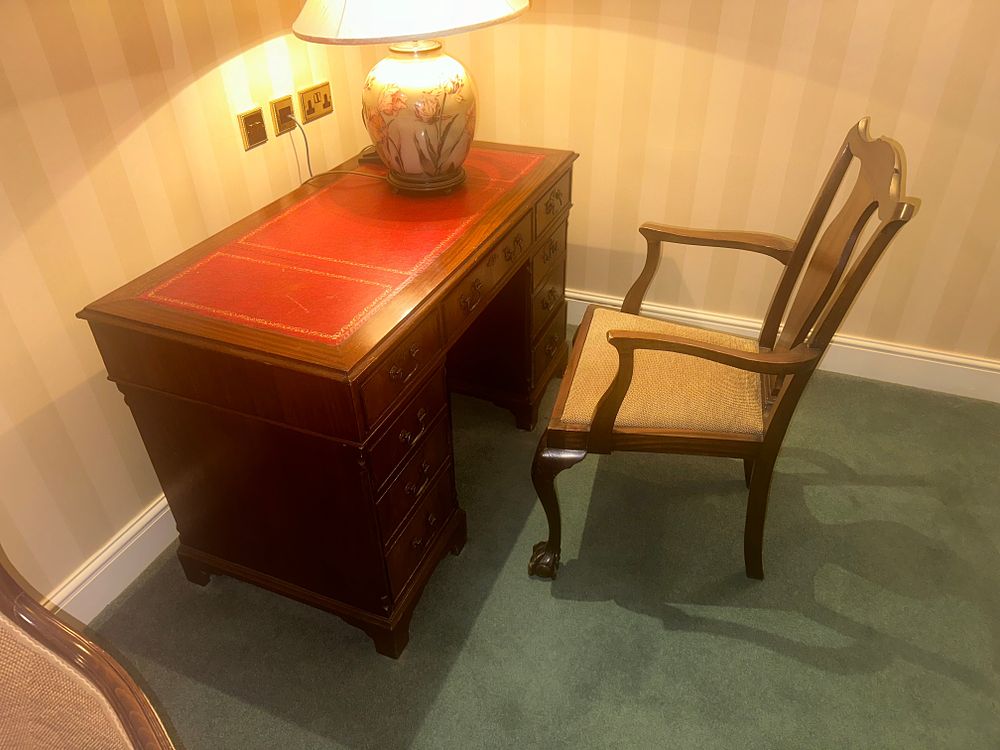 Lot 1554: A Georgian Style Mahogany Pedestal Desk with Leather-Inset Top and an Accompanying Armchair
