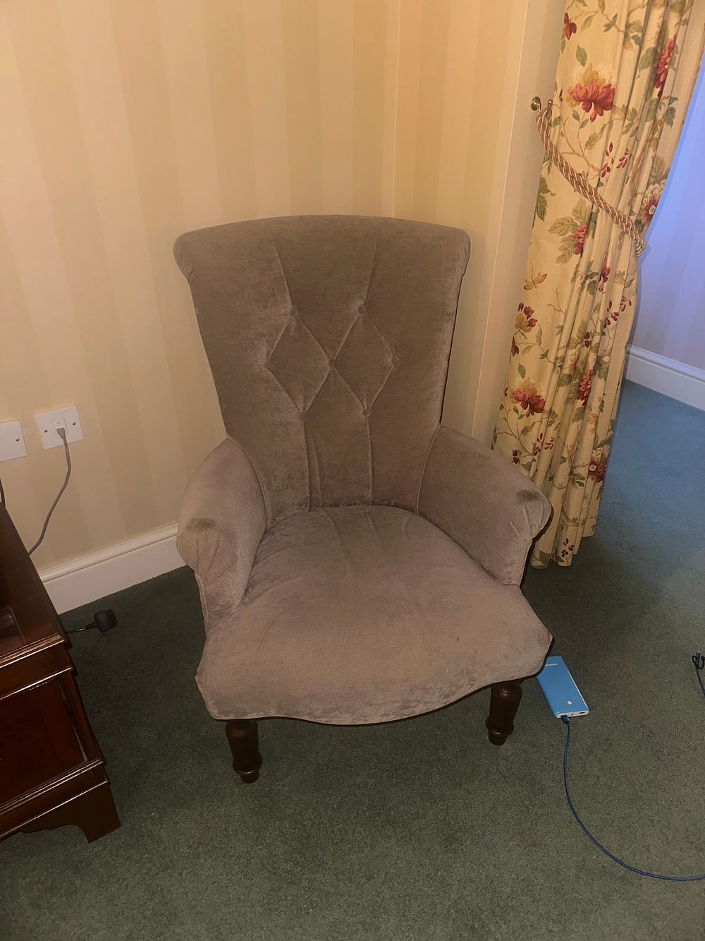 Lot 1556: A High-Backed Upholstered Armchair and a Two-Tier Occasional Table, 20th Century