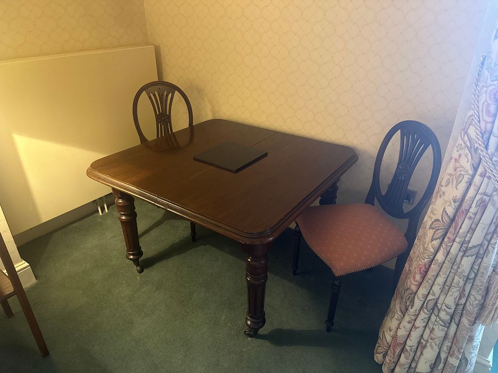 Lot 1595: A Victorian Mahogany Drop-Leaf Dining Table with Two Chairs, a Hexagonal Side Table, and a Five-Drawer Chest