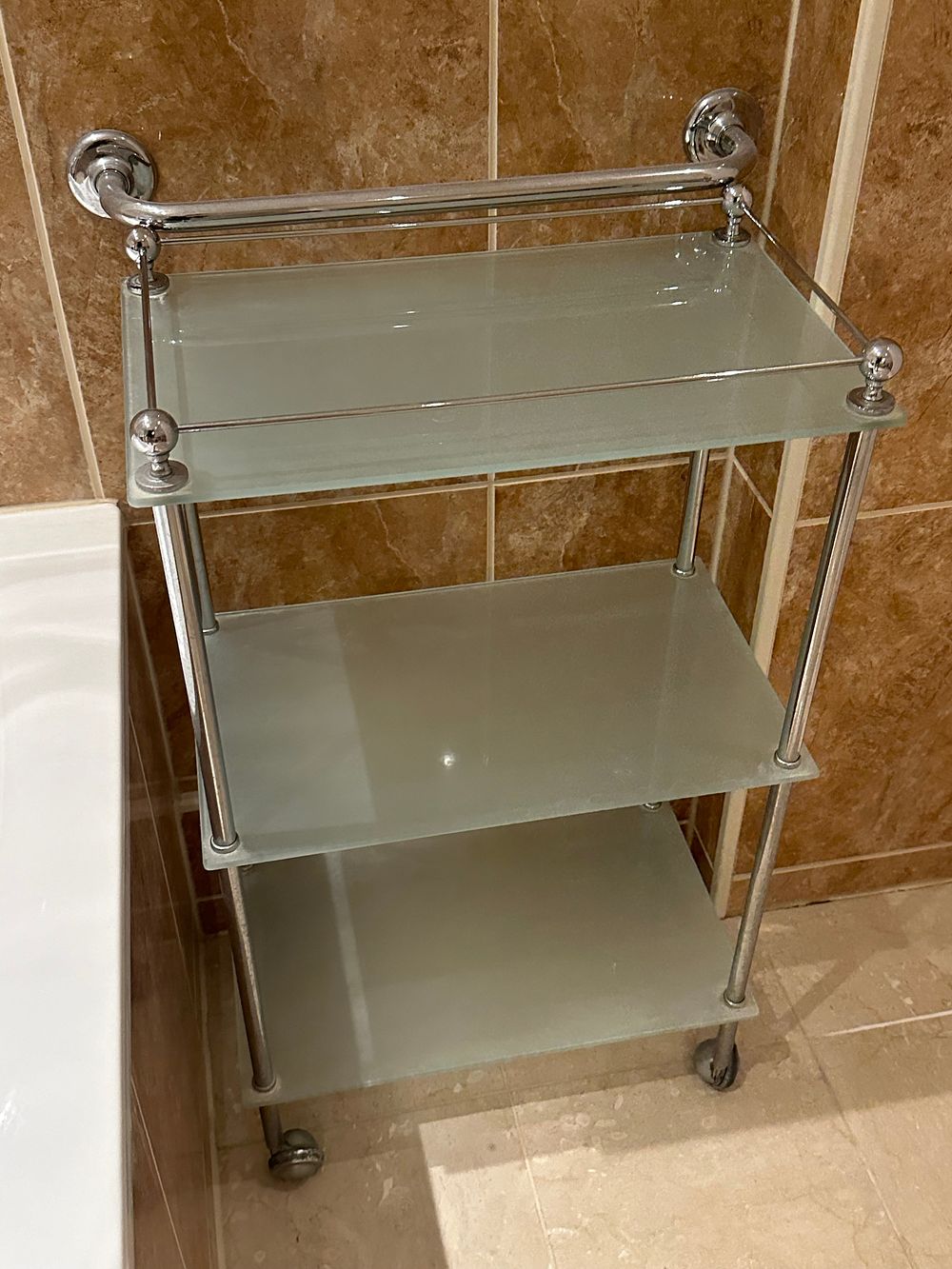Lot 1639: A Contemporary Three-Tiered Frosted Glass and Chrome Mobile Shelving Unit
