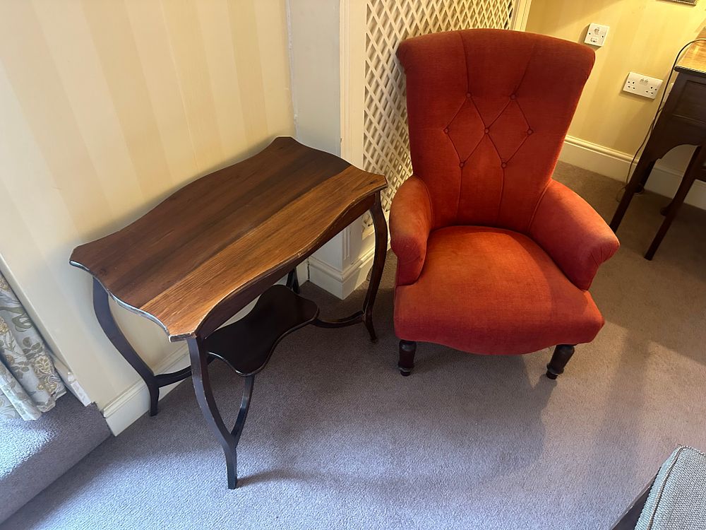 Lot 1704: A Dark-Stained Serpentine Console Table and a Wingback Armchair
