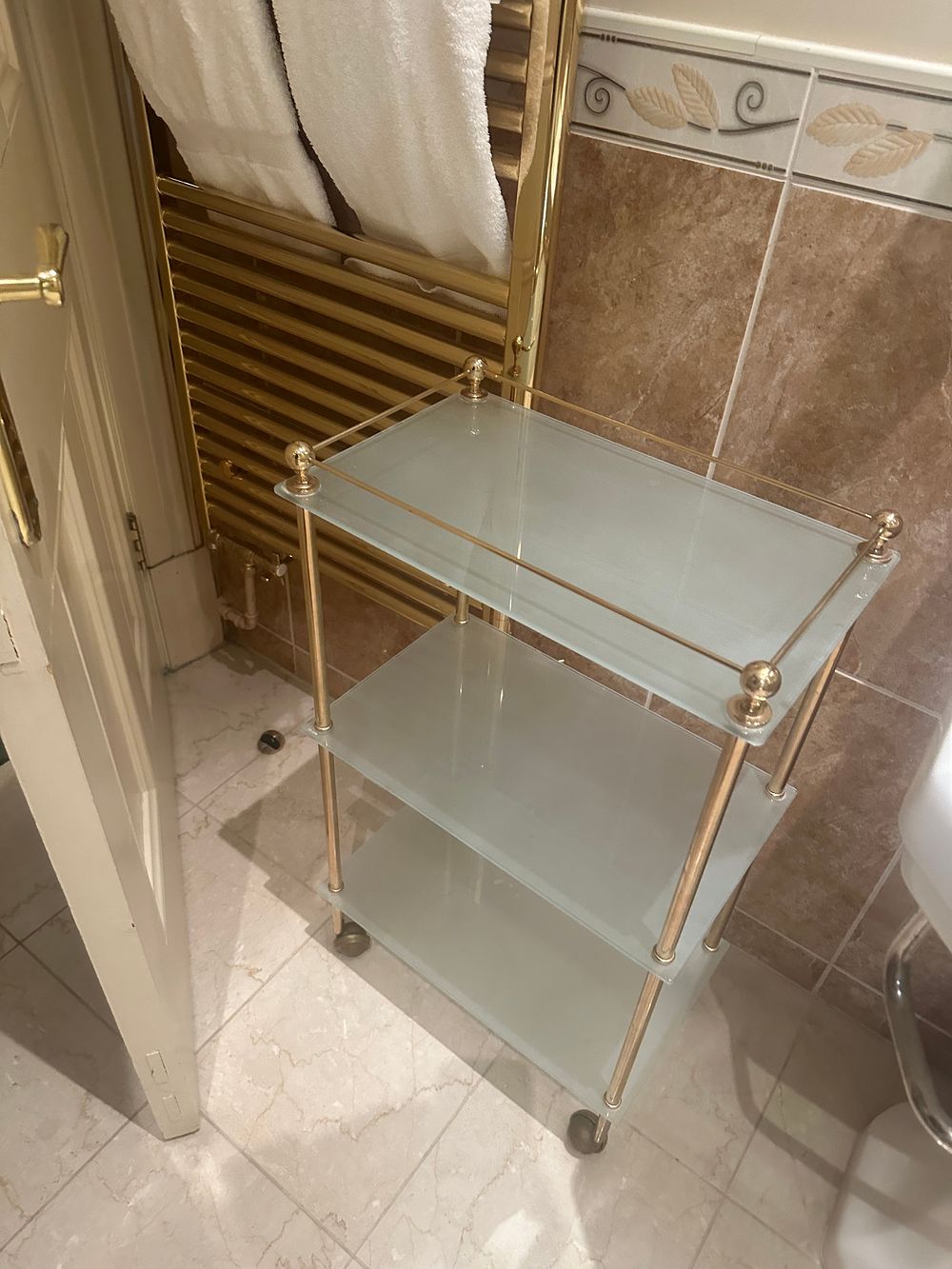 Lot 1741: A Modern Gold-Toned Metal and Frosted Glass Three-Tier Bar Cart