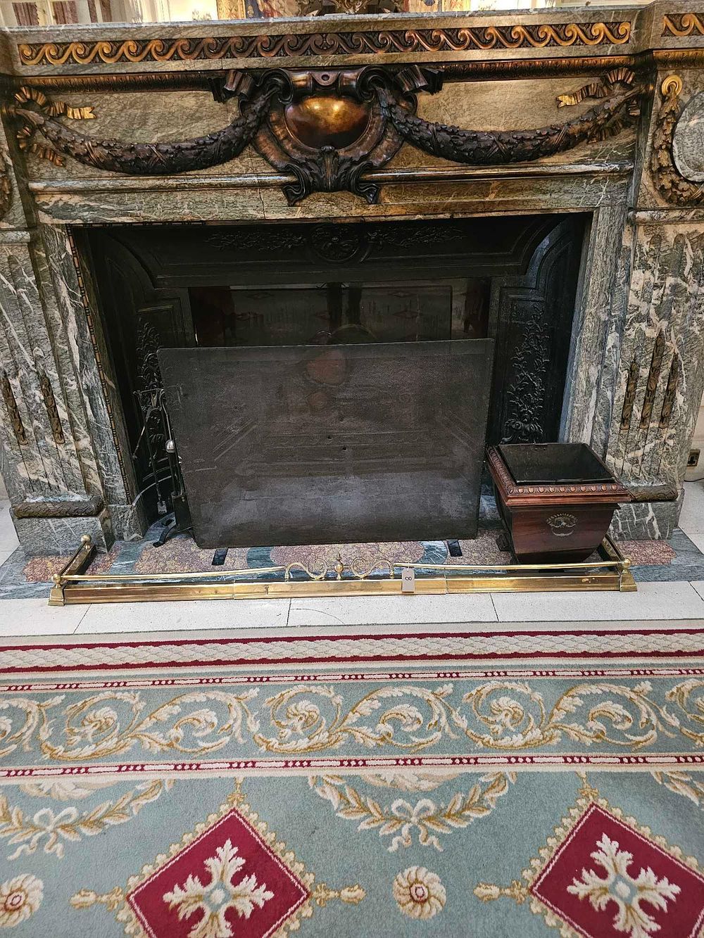Lot 8: A Louis XV Style Variegated Marble Fireplace Ensemble