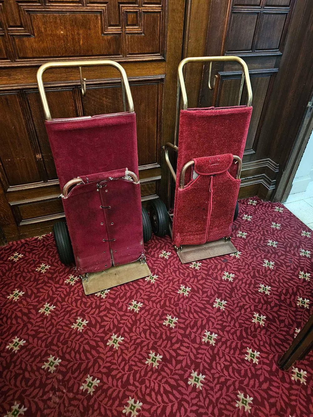 Lot 43: A Pair of Vintage Brass-Toned and Velvet Hotel Luggage Carts