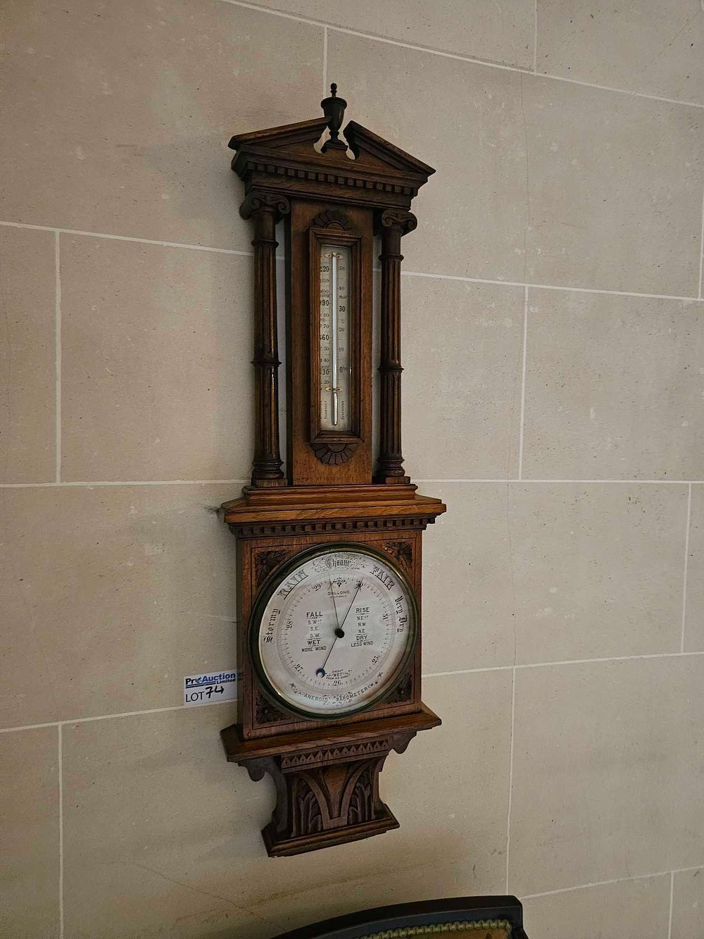 Lot 74: A Late Victorian Carved Oak Aneroid Barometer and Thermometer by Dollond, London