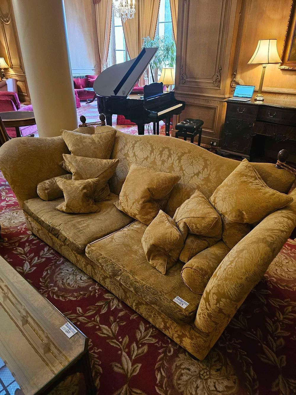 Lot 129: A Large Traditional Rolled Arm Skirted Sofa