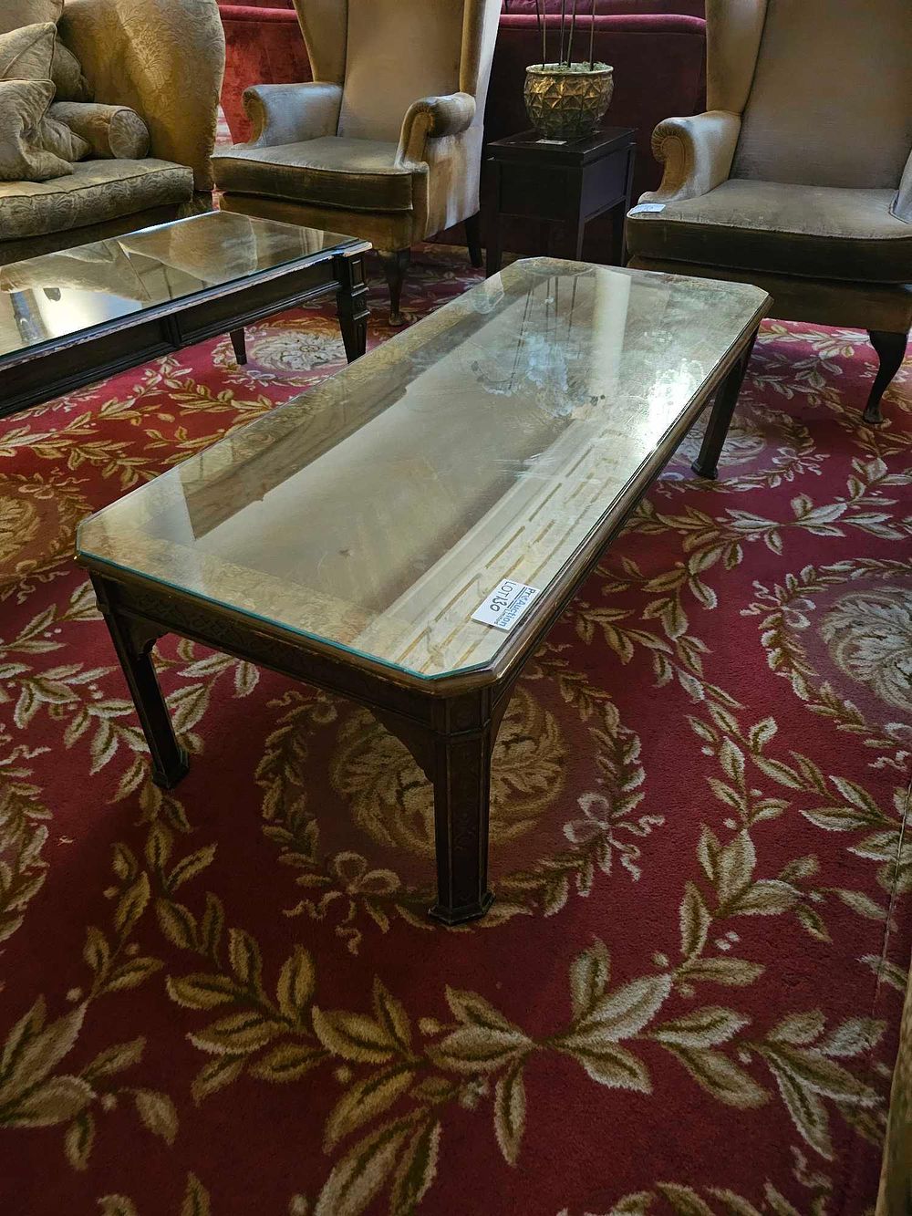 Lot 130: A Decorative Carved and Veneered Cocktail Table with Glass Top