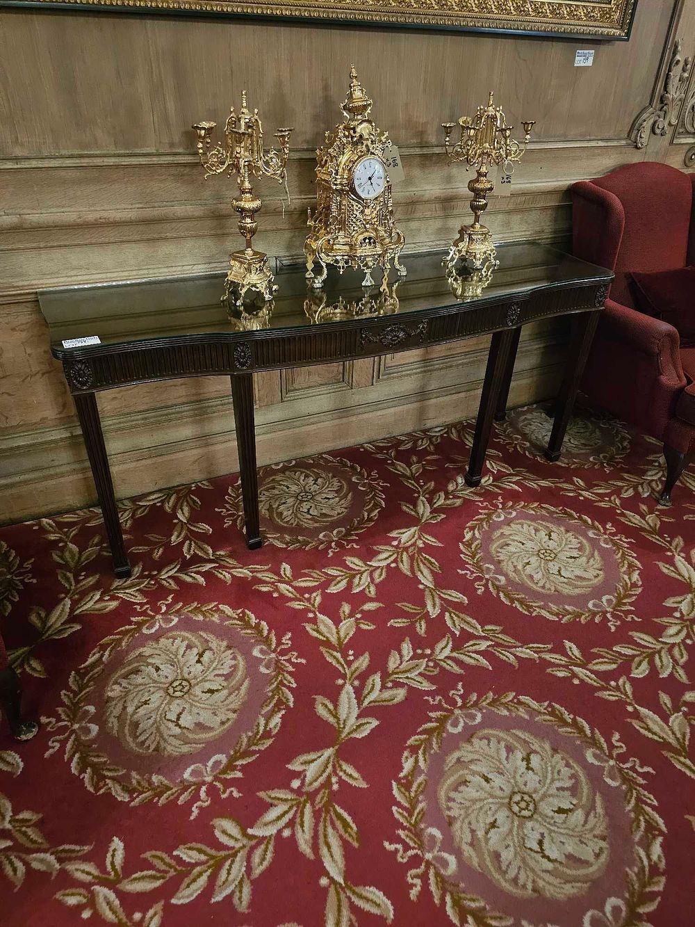 Lot 142: An English Early 19th Century Regency Style Mahogany Console Table and a Three-Piece Gilt Bronze Garniture Set