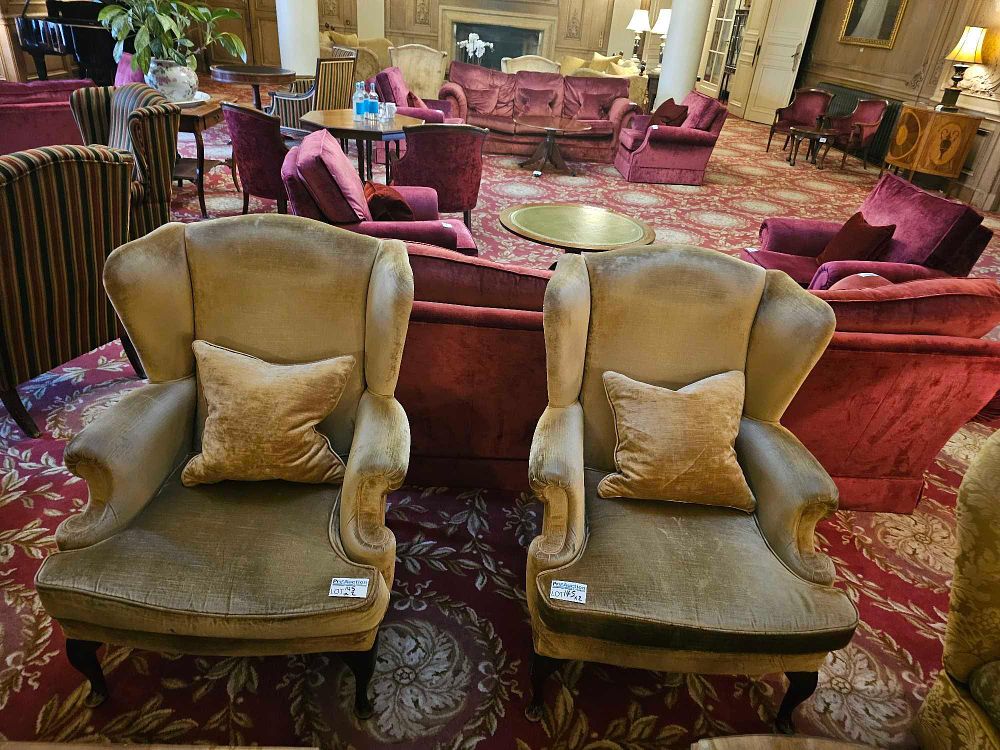 Lot 145: A Pair of Edwardian Style Wingback Armchairs