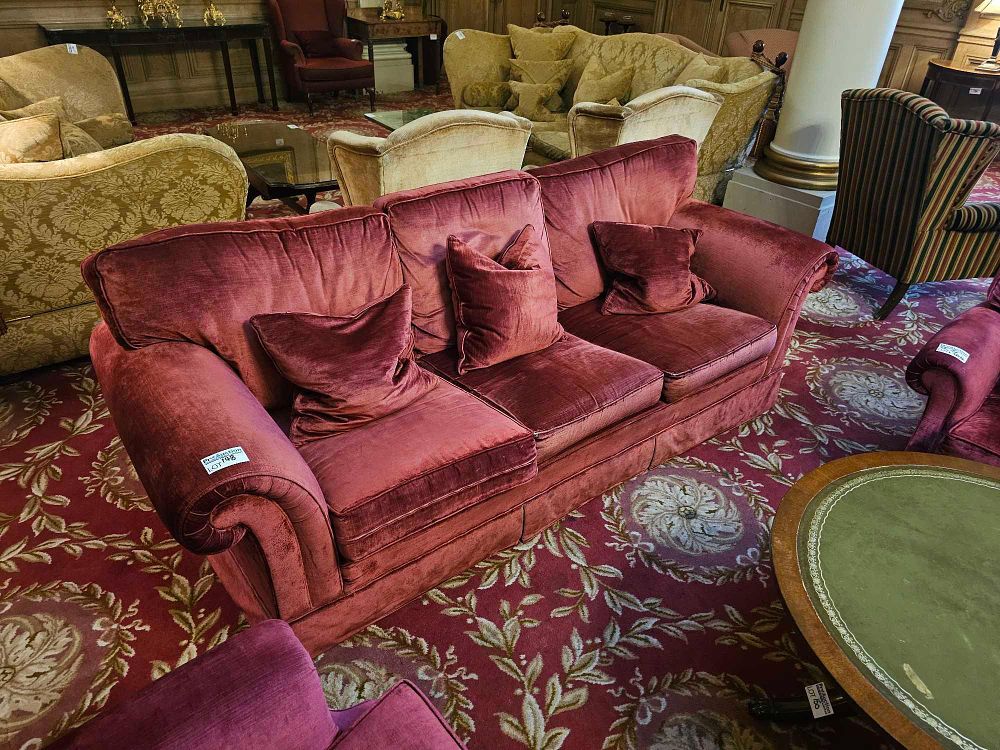Lot 148: A Red Velvet Three-Seater Sofa